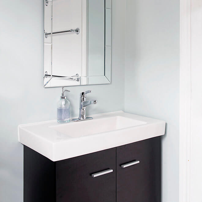 vanity with white vessel sink and beveled mirror