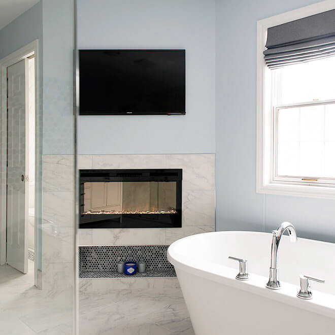 bathroom with fireplace tv soaker tub