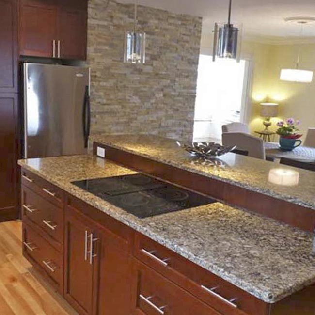 Revitalized Open-Concept Kitchen stone wall dark cabinets hardwood floor